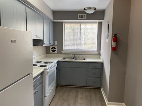 Floor Plan  a kitchen with a stove a sink and a window