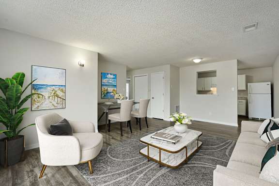 Floor Plan  A living room with a white chair and a coffee table.