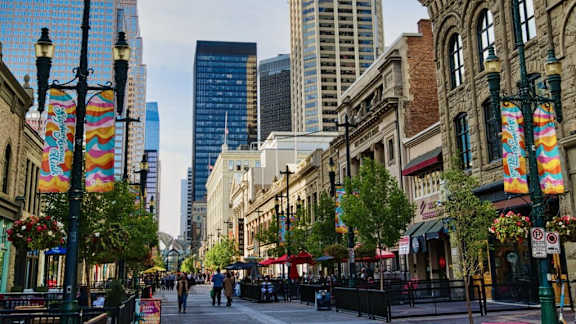 A street scene with people walking and buildings in the background.
