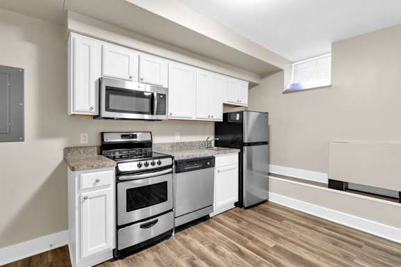 Floor Plan  A kitchen with a black refrigerator, stove, and oven.