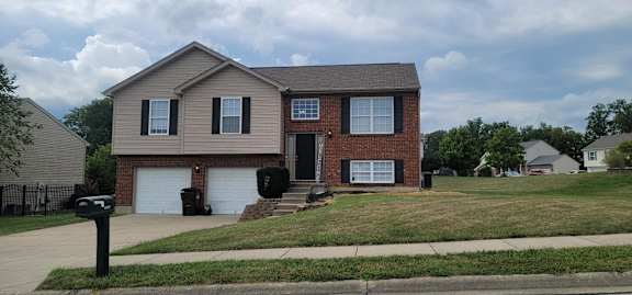 Floor Plan  A two-story house with a garage is situated on a street.