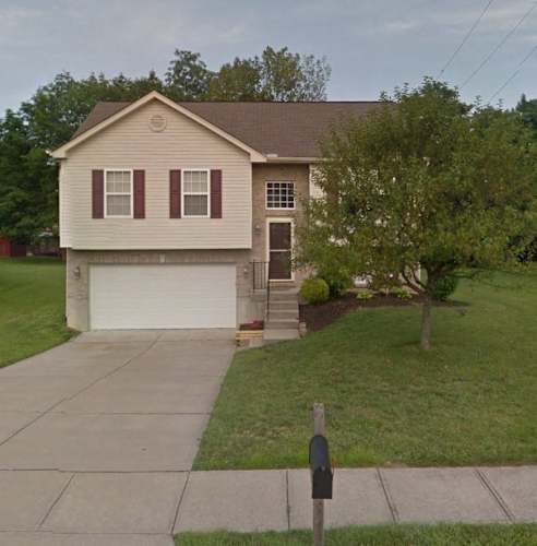 Floor Plan  A house with a brown roof and a white garage door.