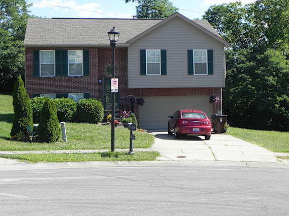 Floor Plan  A red car is parked in front of a house.