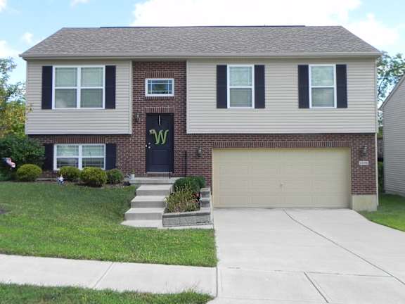 Floor Plan  A house with a black front door and a garage door.