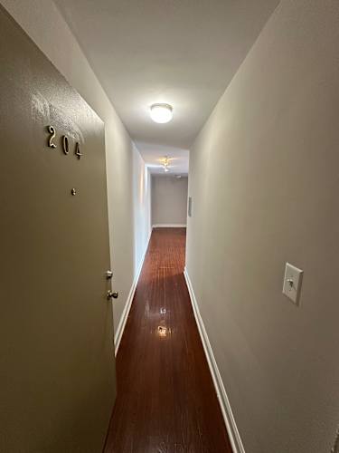 Floor Plan  A hallway with a light on the wall and a number 2023 on the floor.