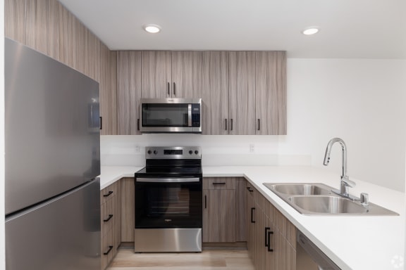 Floor Plan  a kitchen with wooden cabinets and stainless steel appliances