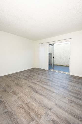 Floor Plan  A room with a wooden floor and a sliding glass door.