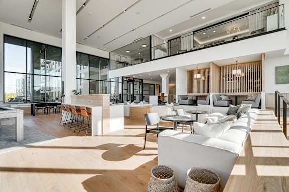 a large lobby with couches and tables and chairs