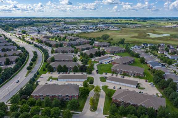 A suburban neighborhood with apartment buildings and a road.