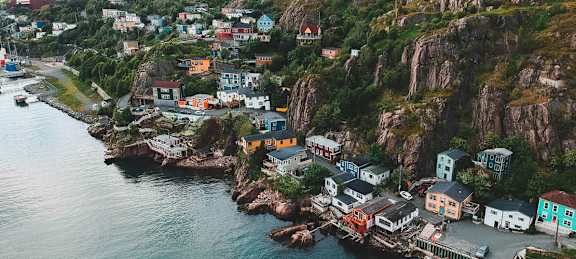 A coastal village with houses built on a cliffside.