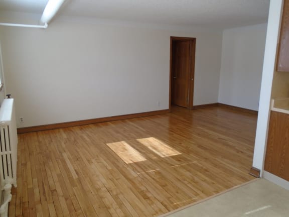 Floor Plan  an empty living room with wooden floors and a door