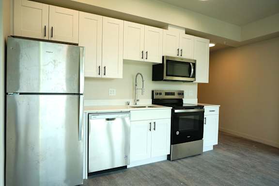 Floor Plan  A kitchen with white cabinets and appliances.