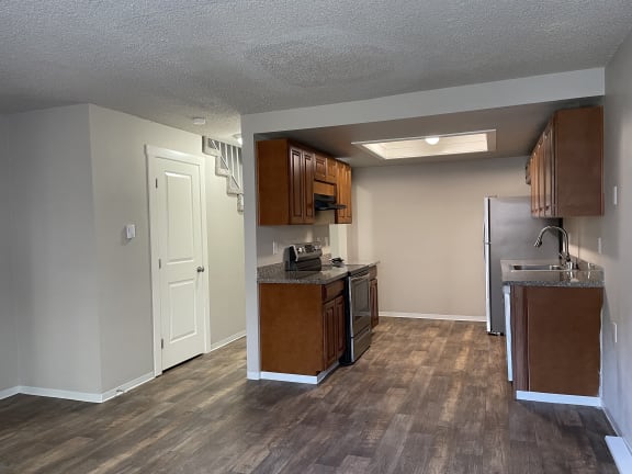 Floor Plan  an empty kitchen with wood flooring and stainless steel appliances