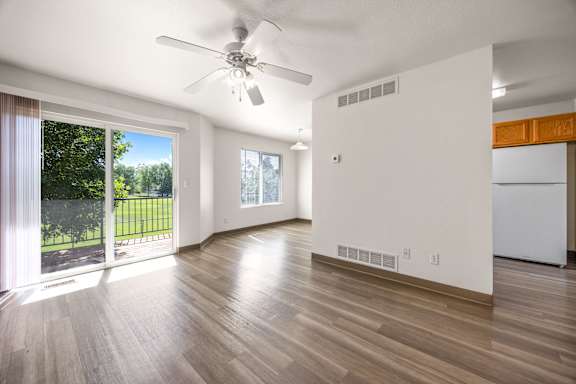 Floor Plan  A room with a ceiling fan and wooden flooring.