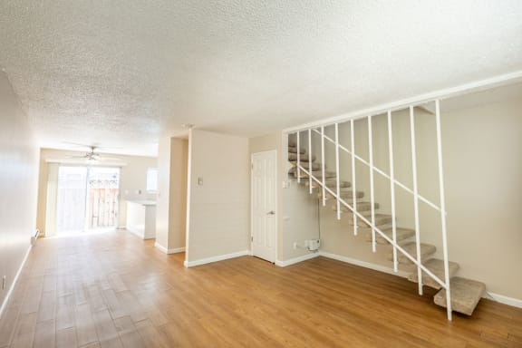 Floor Plan  an empty living room with a staircase leading up to a loft