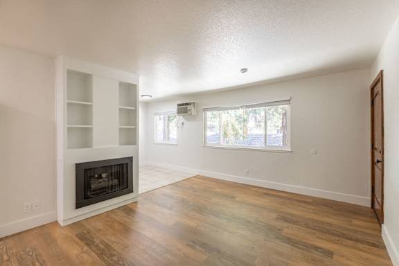 Floor Plan  an empty living room with a fireplace and a window