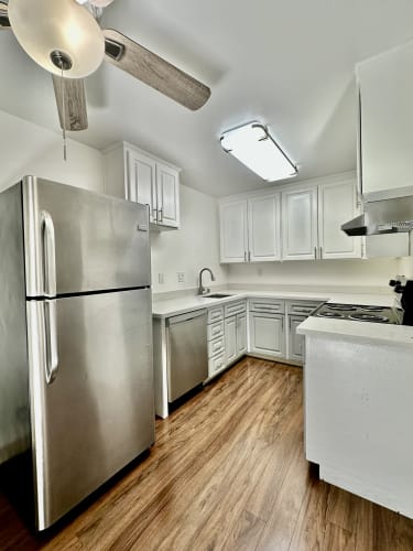 Floor Plan  a kitchen with stainless steel appliances and white cabinets
