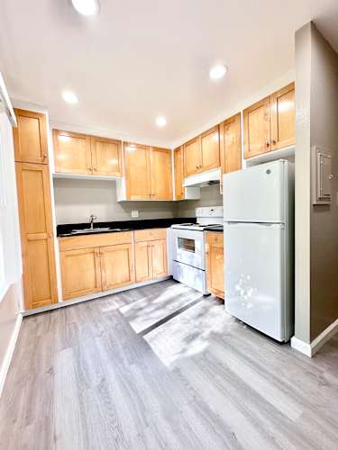 Floor Plan  an empty kitchen with wooden cabinets and stainless steel appliances
