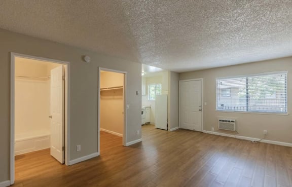 Floor Plan  an empty living room with a hard wood floor and a door to a closet