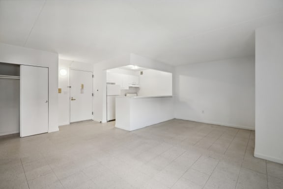 Floor Plan  the living room and kitchen of an apartment with white walls and tiled floors