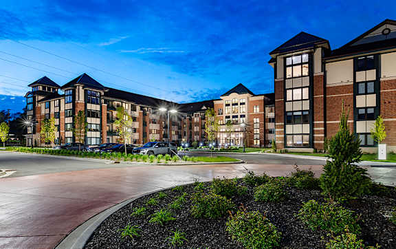A large building with a parking lot in front of it.