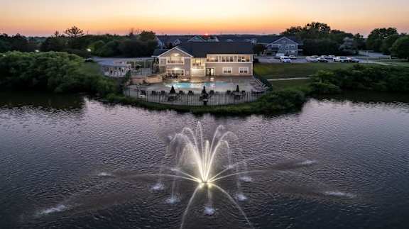 A house with a fountain in front of it.