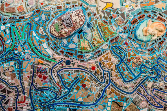 A colorful mosaic of a cityscape with roads and buildings.