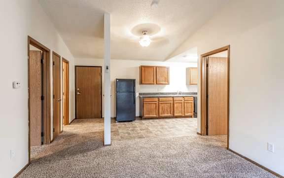 Floor Plan  A room with a blue trash can and wooden cabinets.