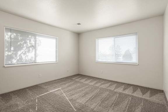 Floor Plan  A room with a carpeted floor and two windows.