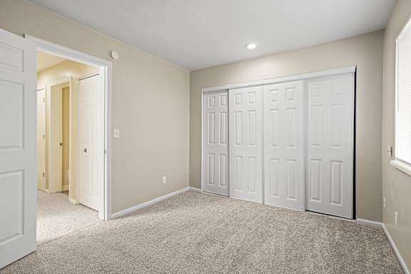 Floor Plan  A room with white doors and carpeted floor.