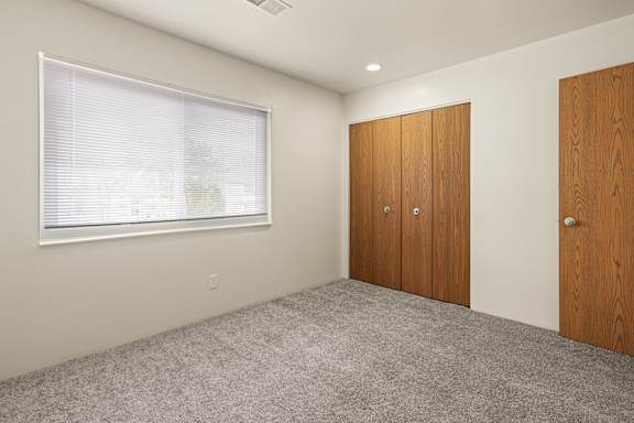 Floor Plan  A room with a window and two wooden doors.