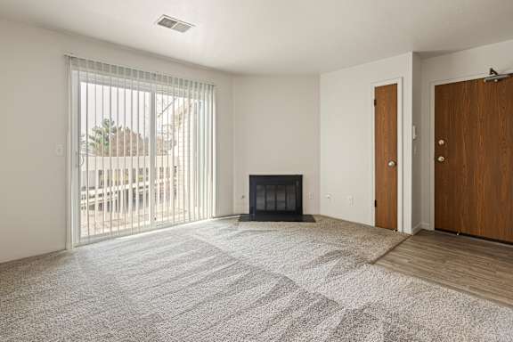 Floor Plan  A room with a fireplace and sliding glass doors.