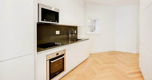 Floor Plan  A kitchen with a microwave, oven, and sink.