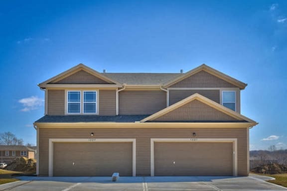 Floor Plan  a brown house with two garage doors