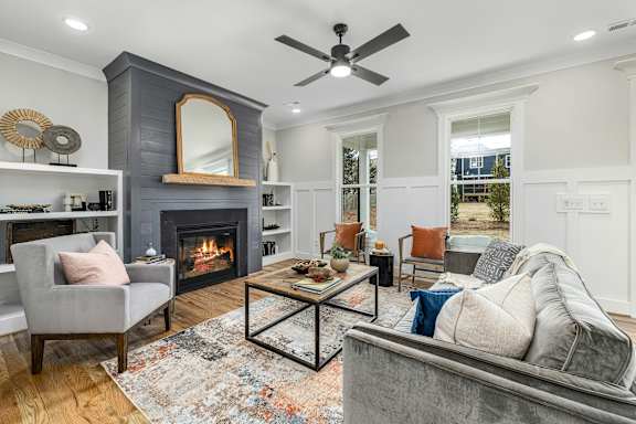 Floor Plan  a living room with a fireplace and a ceiling fan