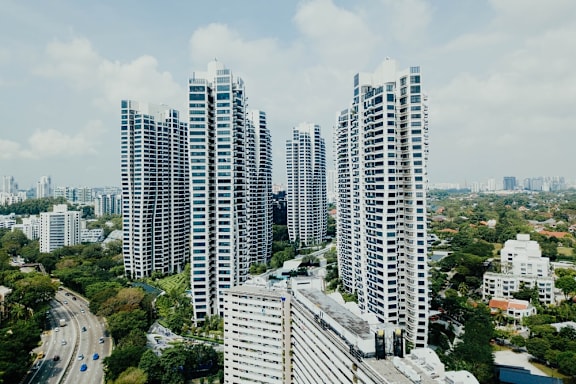 A cityscape with tall buildings and a highway.