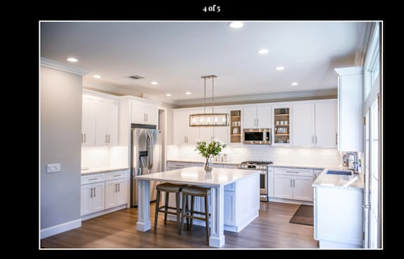 Floor Plan  A modern kitchen with white cabinets and a central island.