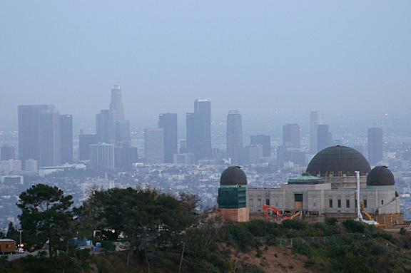 A city skyline with a large observatory in the foreground.