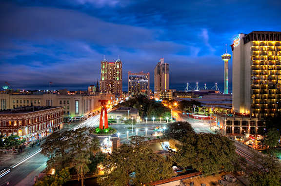 A cityscape at night with a large monument in the center.