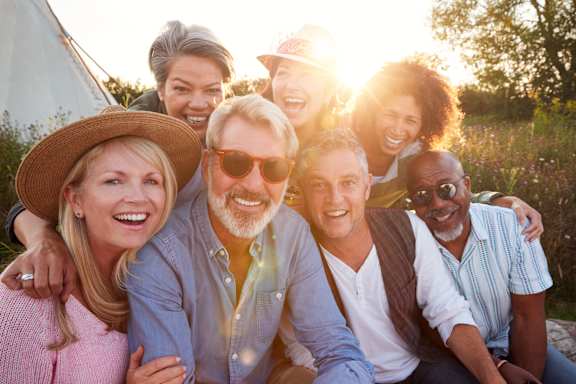 group of people posing for a picture in the sun