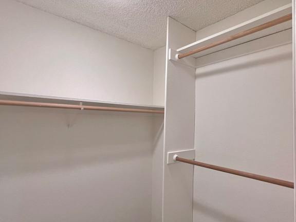 a walk in closet in a 555 waverly unit