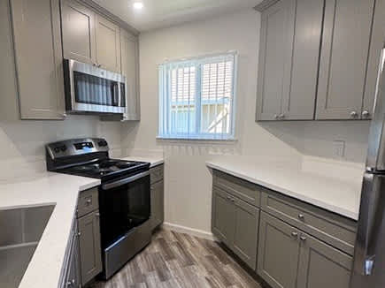 A kitchen with a stove top oven and microwave.