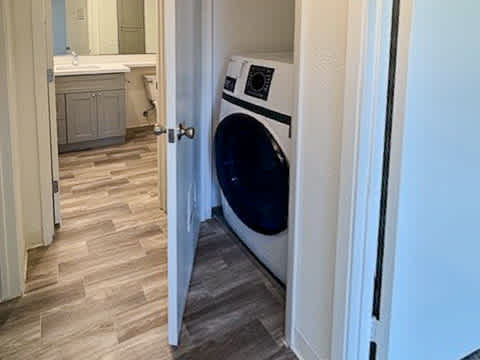 A washing machine is in a doorway.