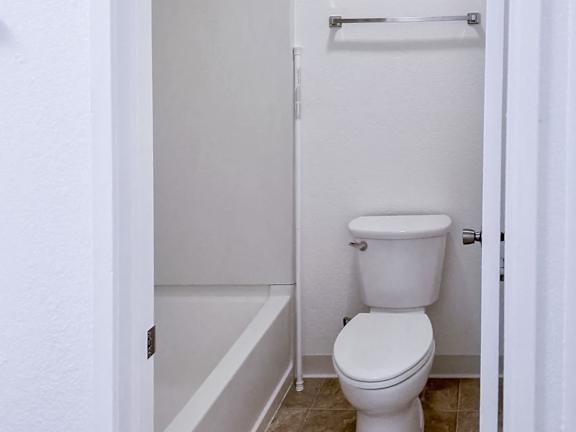 A white toilet in a small bathroom.
