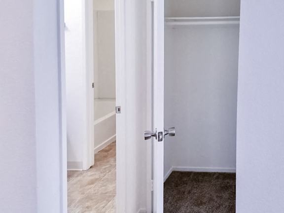 A white door with a silver handle is open.