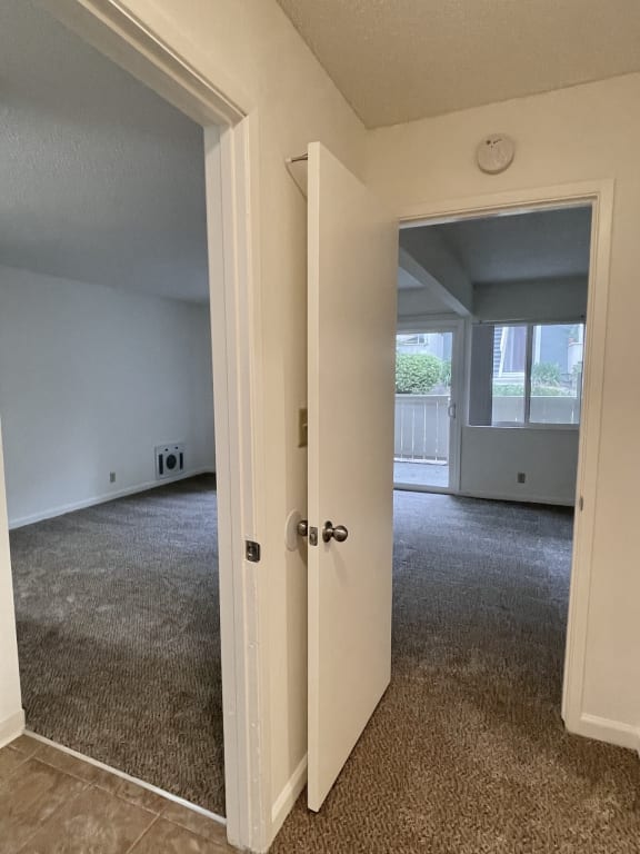an empty living room with an open door