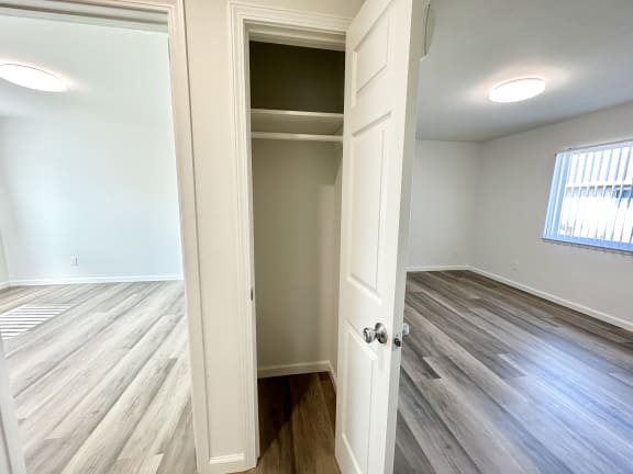 a bedroom with a closet and a window