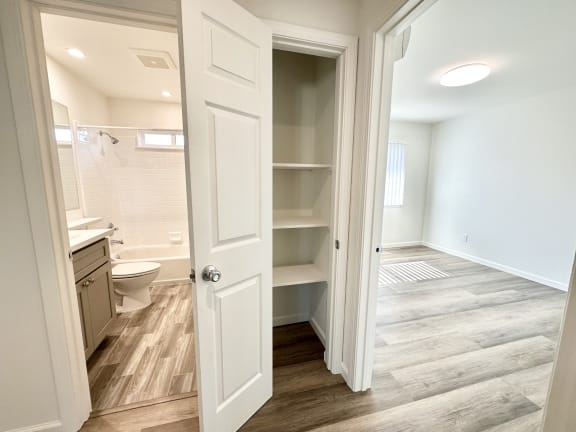 a bedroom with a medium sized bed and a bathroom with a toilet and a sink