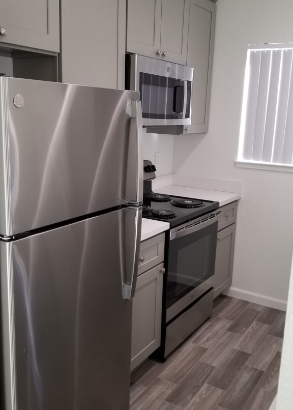 a kitchen with stainless steel appliances and a refrigerator