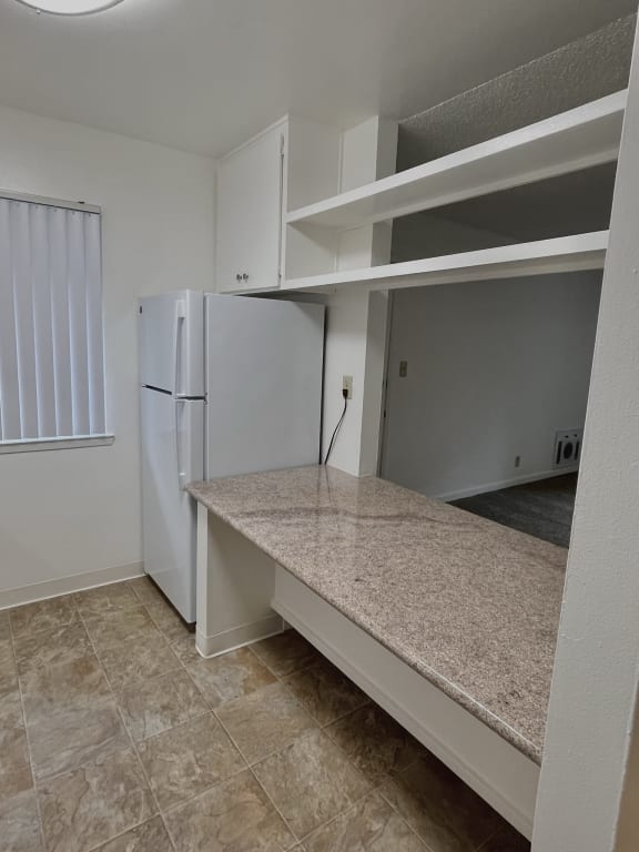 a kitchen with an island and a refrigerator
